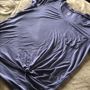 A purple So shirt with a knot on the bottom